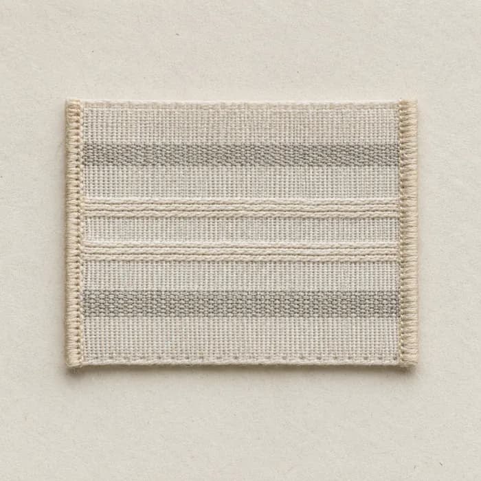 Macro view of a blank woven composition label on pale paper